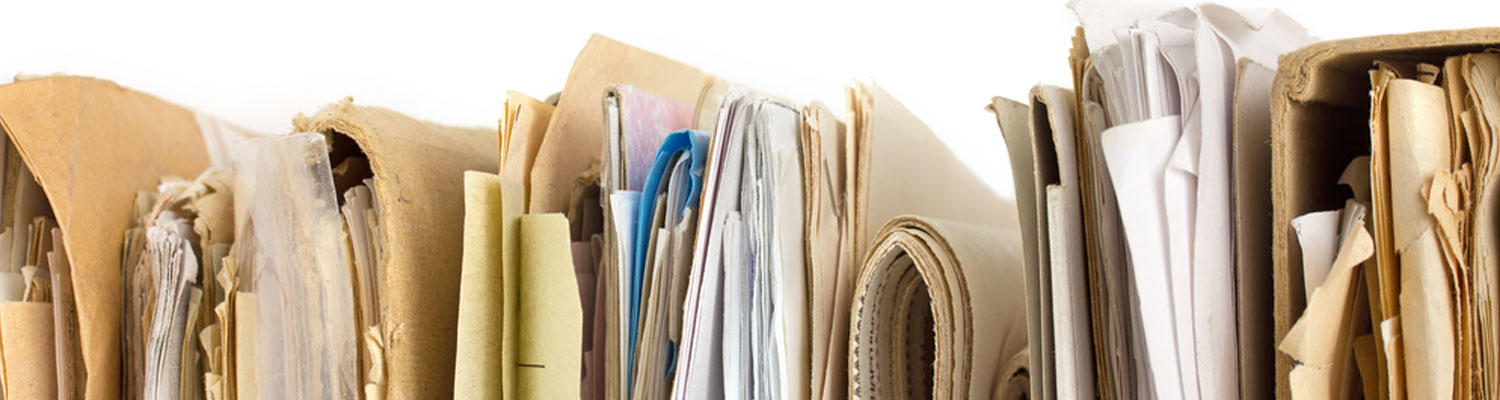 A decorative image displaying a sample of old paper files smashed together