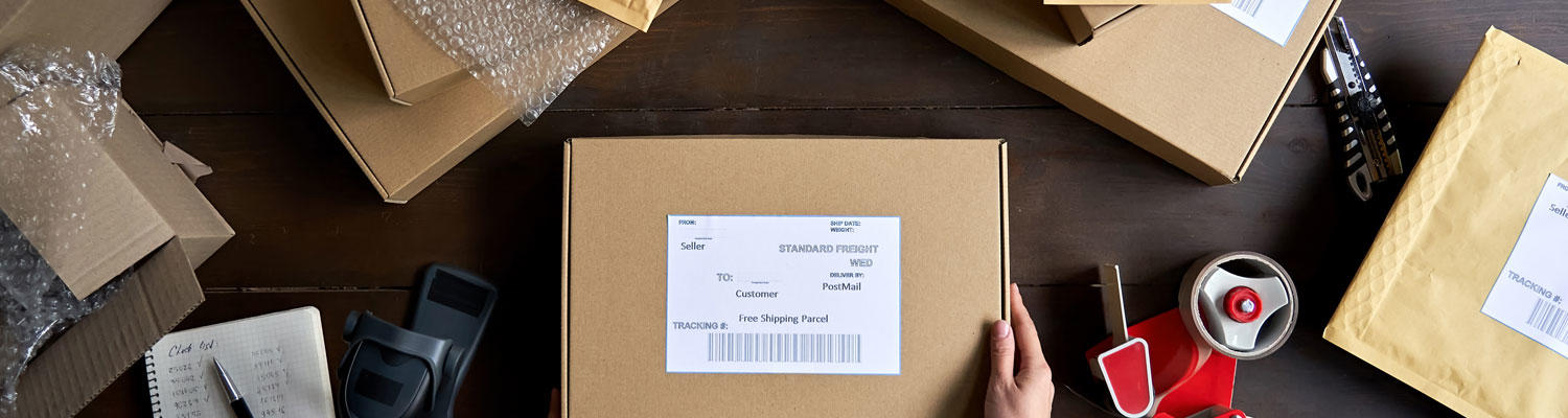 IDS Fulfillment and Kitting image showing a group of shipping boxes with labels at a shipping station ready to mail packages out.