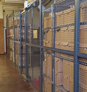 A warehouse secure storage cage area with boxes.