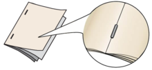 Bindery image showing what a side stitch bind looks like, two staples on the front of the booklet, one top, one bottom.