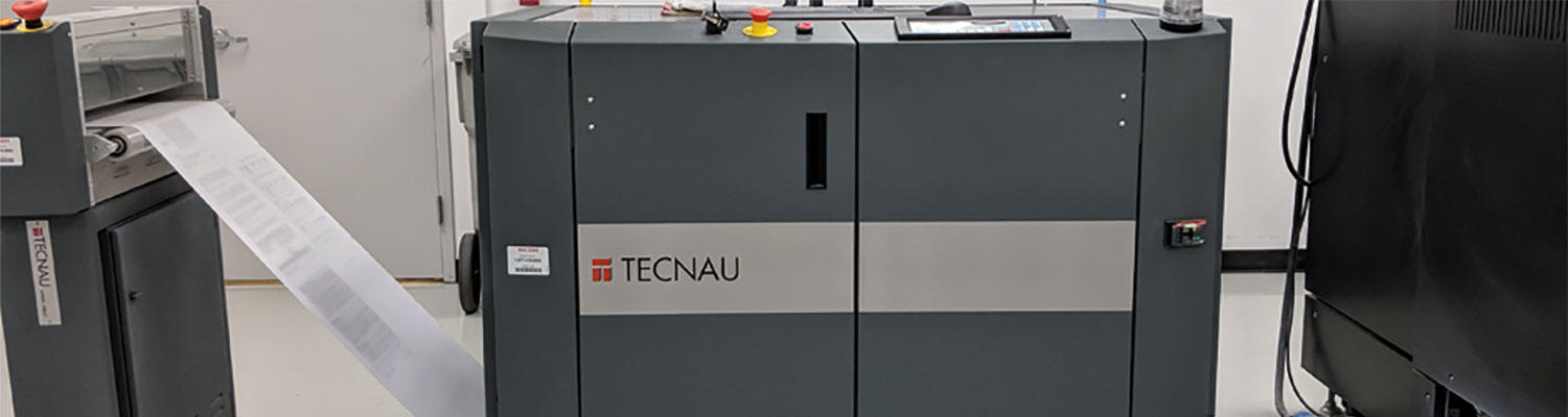 A large commercial size digital printer with paper rolling through